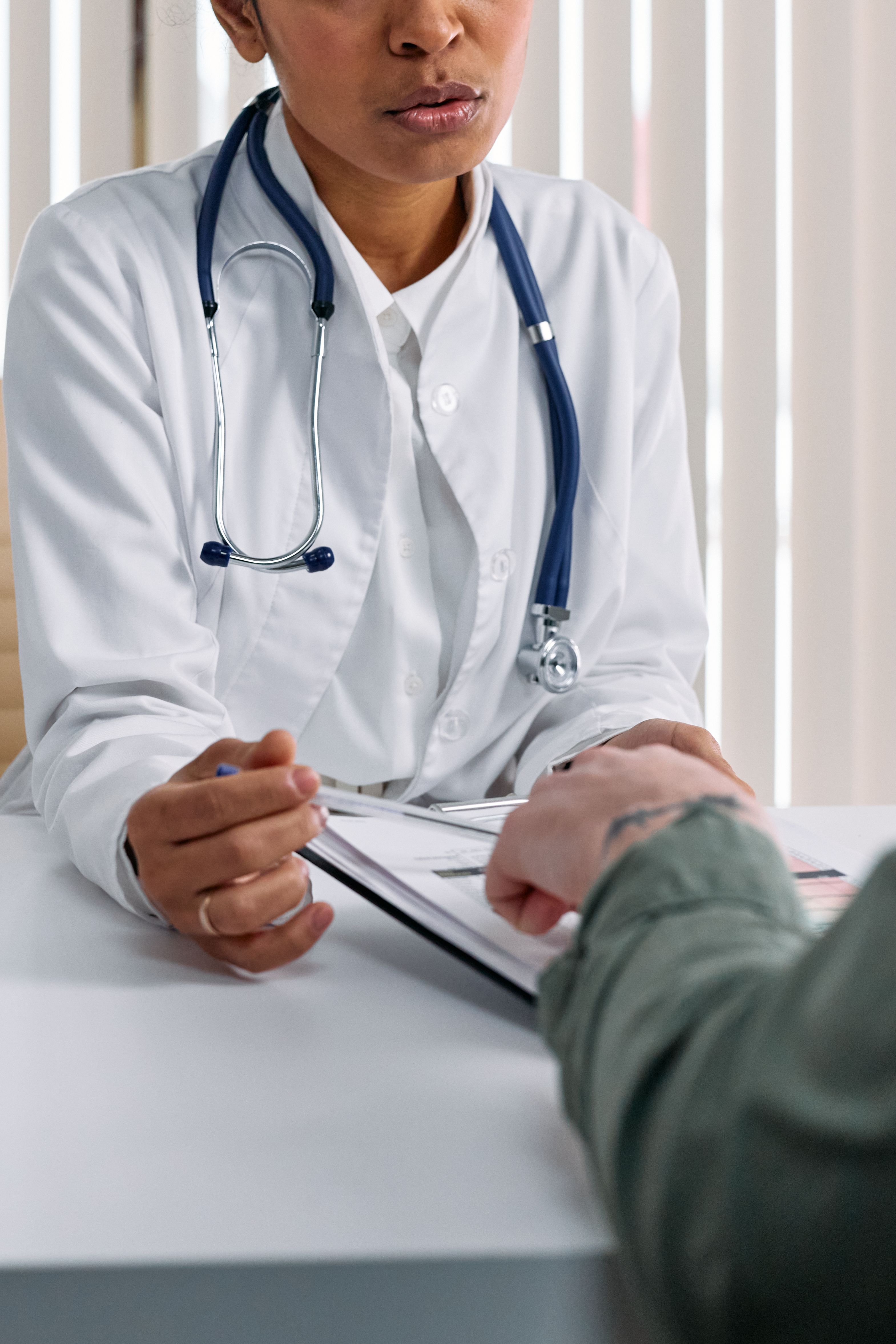 Healthcare professional reviewing a chart with a patient